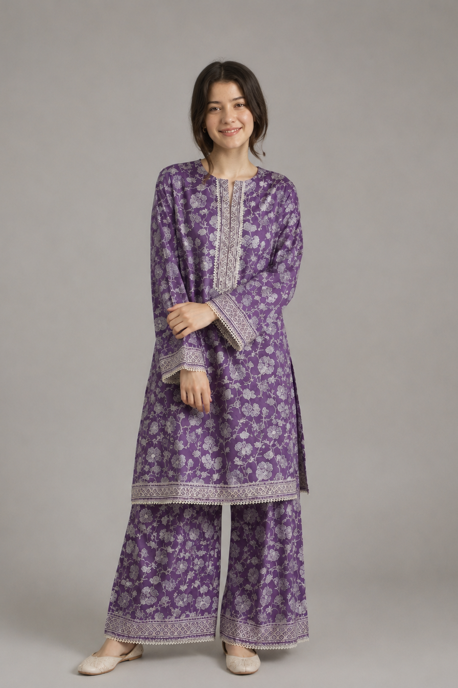 Woman wearing a purple floral outfit on a gray background