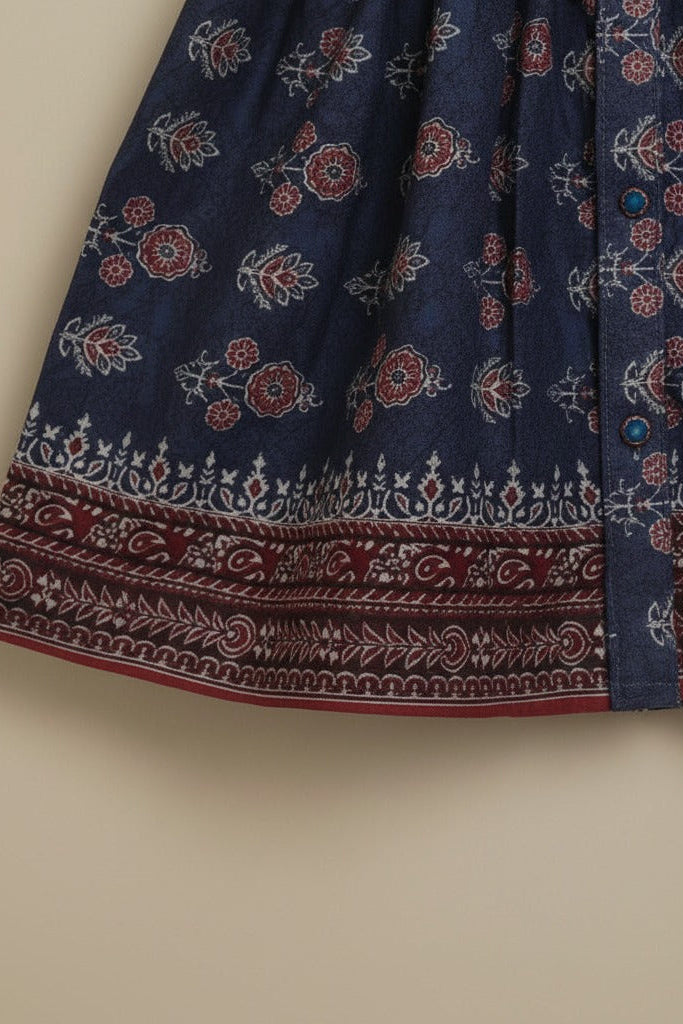 Navy blue shirt with red and white floral pattern on a beige background
