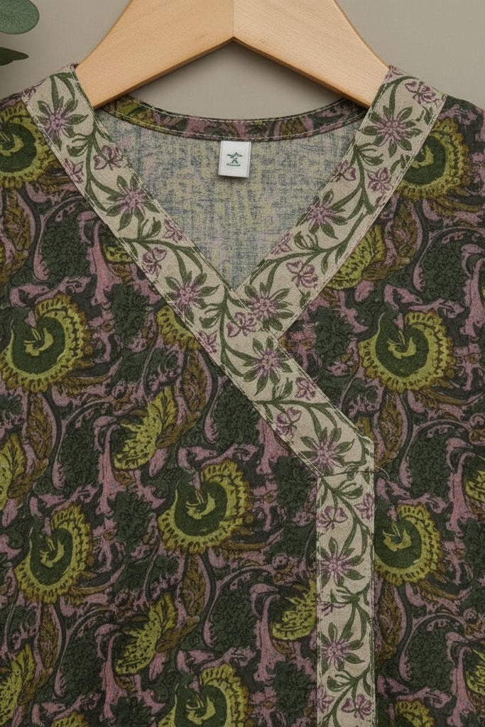Patterned garment on a hanger with a neutral background