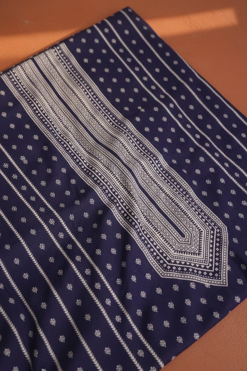 Navy blue fabric with white geometric patterns on a wooden surface