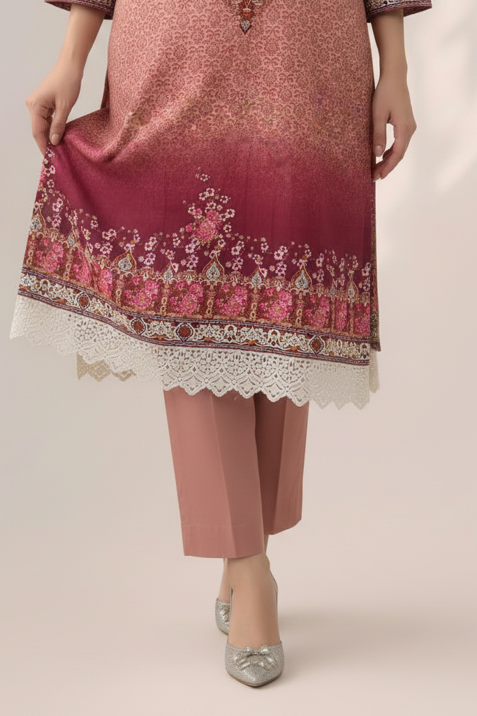 Pink traditional outfit with intricate embroidery on a plain background