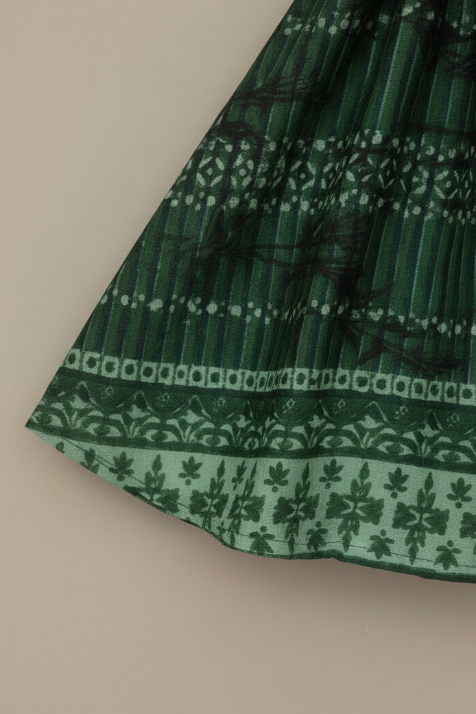 Green patterned fabric on a beige background