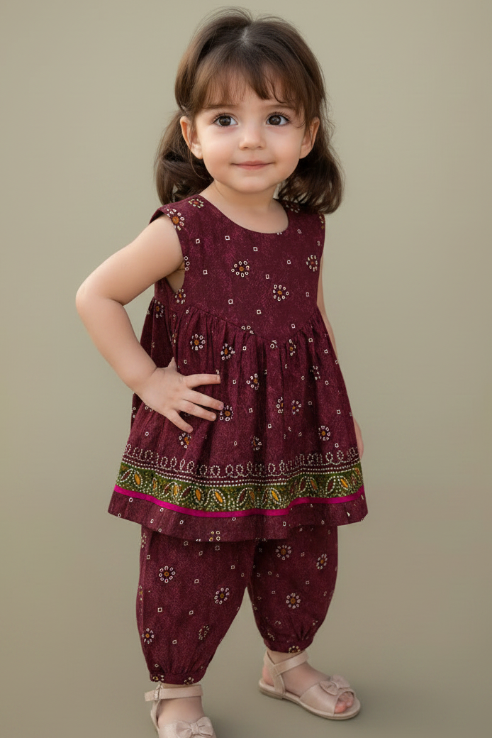 Child wearing a maroon traditional outfit with floral patterns on a beige background
